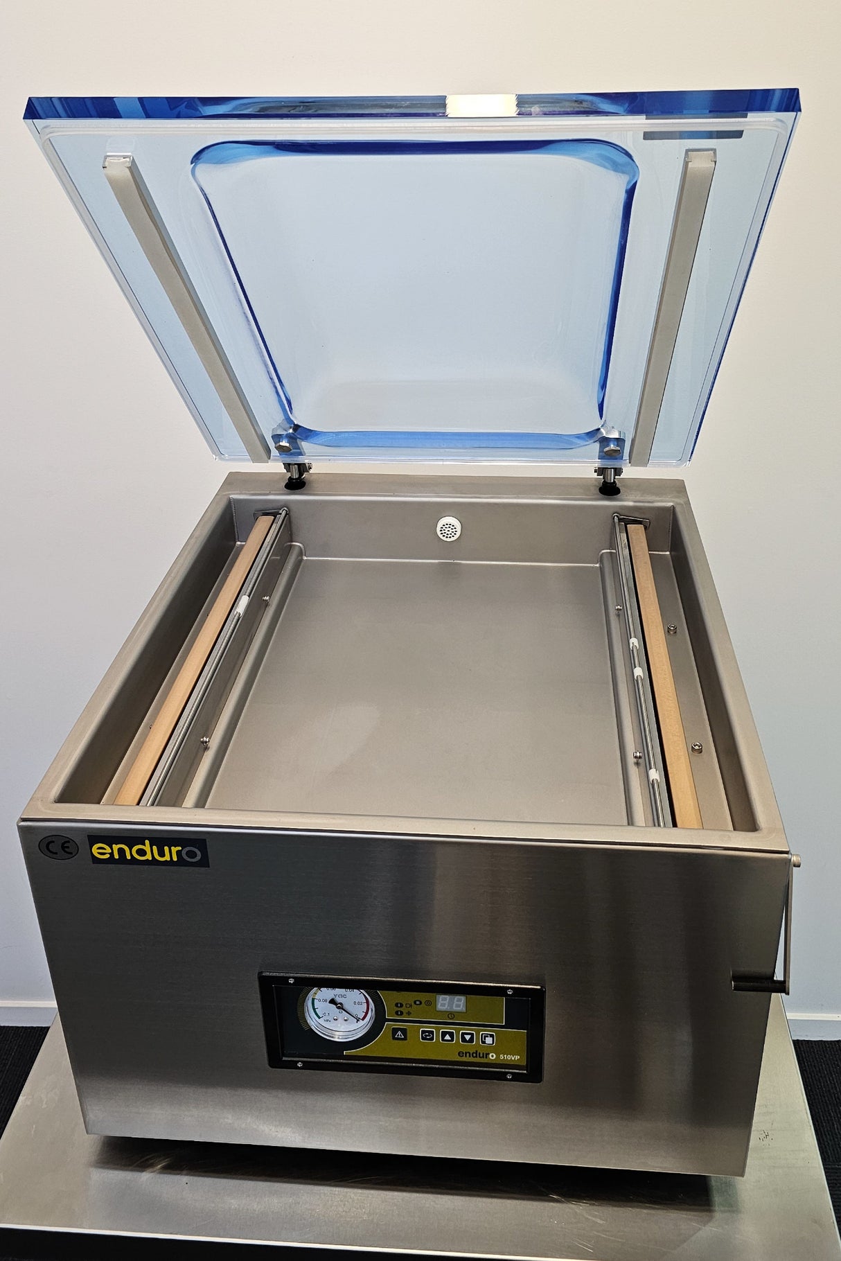 Stainless steel vacuum sealing machine with open lid on a white background