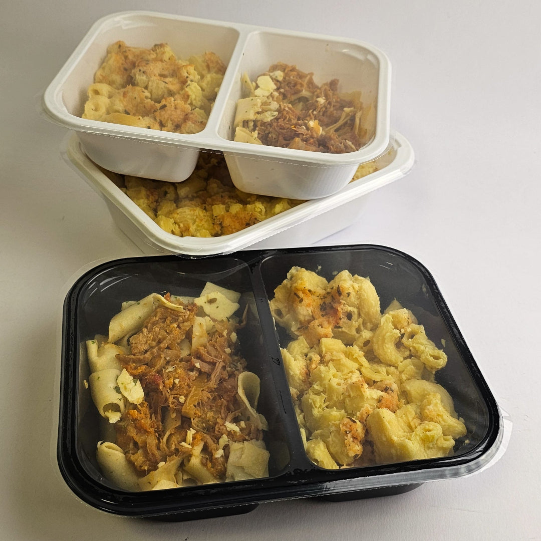 Three containers of pasta with different toppings on a white surface