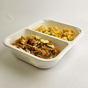 Two compartments of food in a white container on a light gray background
