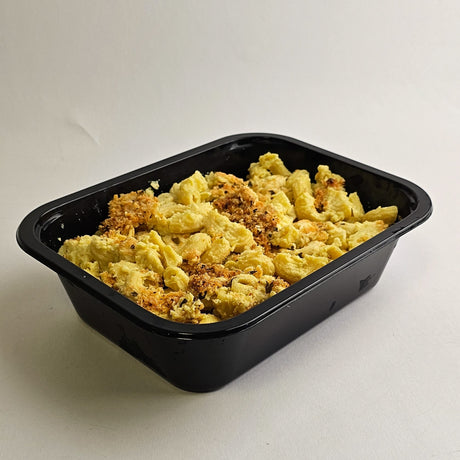 Black plastic container with macaroni and cheese on a white background