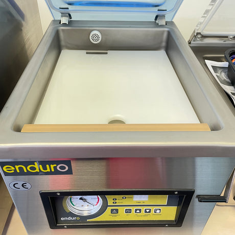 A stainless steel vacuum packer machine with a digital display and control panel, branded 'enduro'.