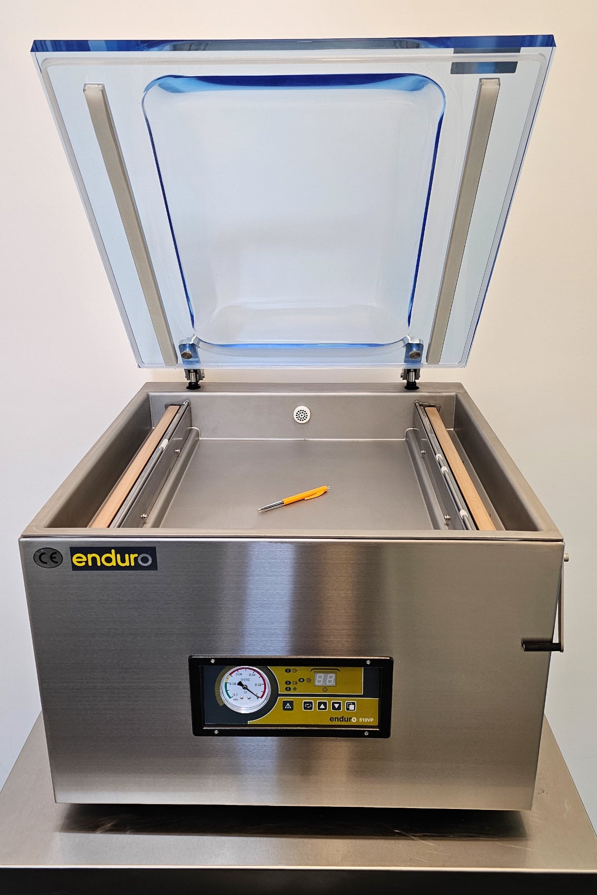 Stainless steel vacuum chamber with open lid on a white background
