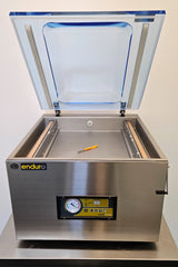 Stainless steel vacuum chamber with open lid on a white background