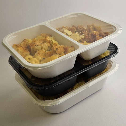 Stack of food containers with macaroni and cheese on a light gray background