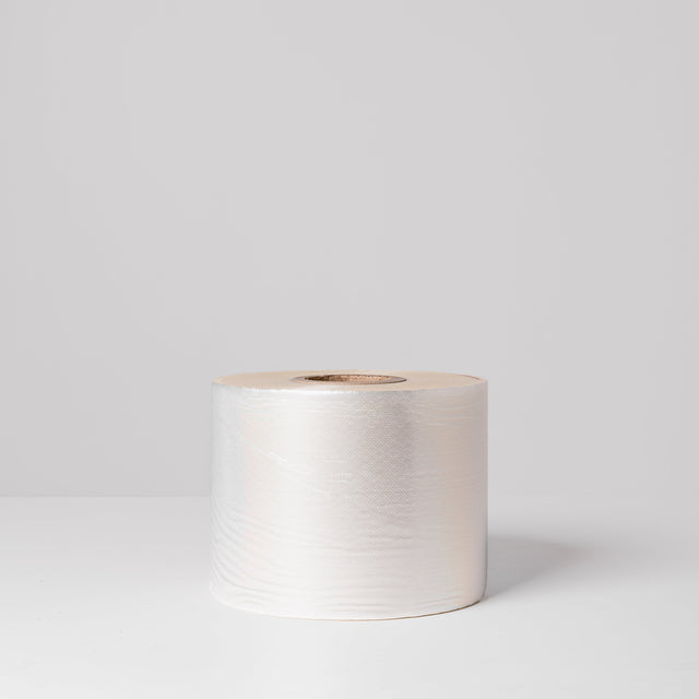 A roll of white, perforated lidding film for food packaging.