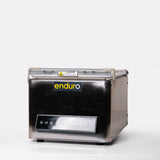 A benchtop Enduro vacuum packer with a stainless steel and acrylic design, featuring a control panel and a transparent viewing window.
