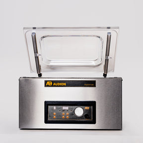 A Audion benchtop vacuum packer with a clear acrylic lid, digital control panel, and stainless steel body.
