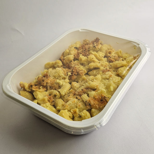Macaroni and cheese in a white container on a light gray background